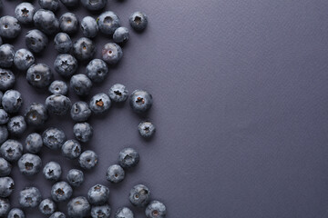Blueberries on a dark blue background. Top view. Copy space