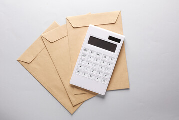 Calculator with an envelopes on a gray background. Payment of taxes. Business concept