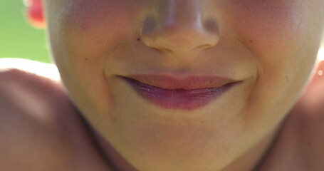 Close-up of Child lips smiling, extreme closeup of kid
