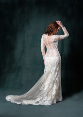 Fototapeta premium full length of joyful middle aged bride in white wedding dress