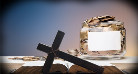 Golden coins and Holy Bible book on the desk