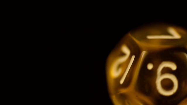 Yellow d12 tabletop board game die rotating gamer close-up footage dice