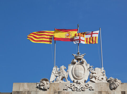 Flags flying above barcelona town hall (from left catalan spanish and city of barcelona flags); Barcelona spain