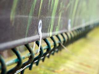Attaching a banner to a mesh fence with zip ties