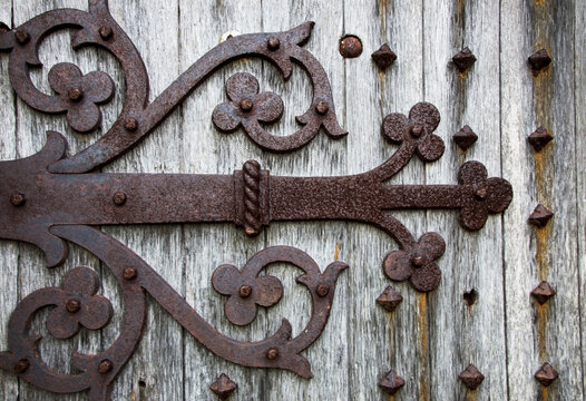 Decorative metal pieces rusted on a wooden wall; Dumfries and galloway scotland