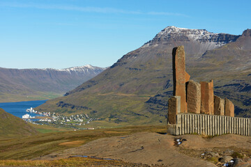 Monument To A Bus Driver Who First Forged A Link Between Egilsstadir And Seydisfjordur, Seydisfjordur Can Be Seen In The Valley; Iceland