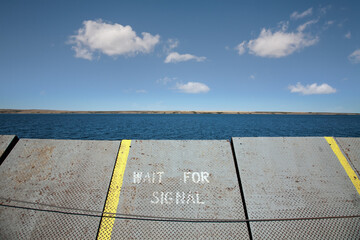 A Ramp At The Water's Edge With A Sign To Wait For Signal; Saskatchewan, Canada