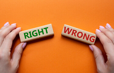 Right or Wrong symbol. Concept word Right or Wrong on wooden blocks. Businessman hand. Beautiful...