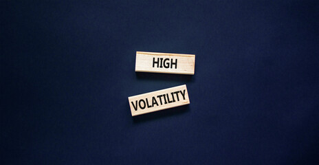 High volatility symbol. Concept words High volatility on beautiful wooden blocks. Beautiful black table black background. Business high volatility concept. Copy space.