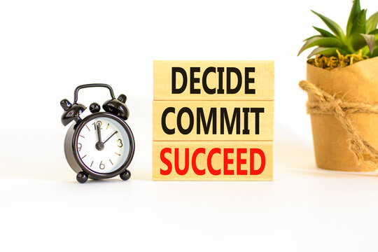 Decide commit succeed symbol. Concept word Decide Commit Succeed on beautiful wooden block. Black alarm clock. Beautiful white table background. Business decide commit succeed concept. Copy space.