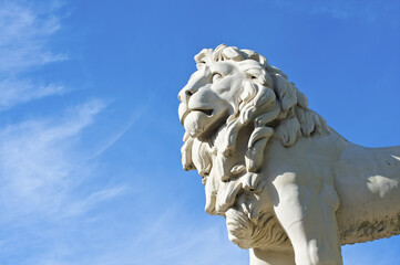 Statue Of A Lion Against A Blue Sky, Trafalgar Square; London, England
