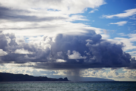 Rain Cloud Dumping Water Over The North Shore Of Maui; Maui, Hawaii, United States Of America