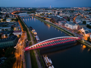 Krakow, Poland, aerial view of the Kazimierz and Podgorze districts with Vistula river bridges in the night - 648273344