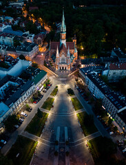 St Joseph church on Rynek Podgorski square, Krakow, Poland, aerial view in the night - obrazy, fototapety, plakaty