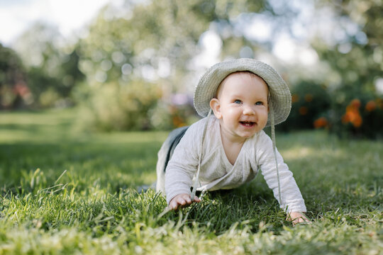 happy baby crawling on the grass in nature. High quality photo