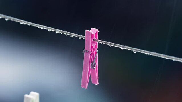 Footage of clothespins in the rain. 