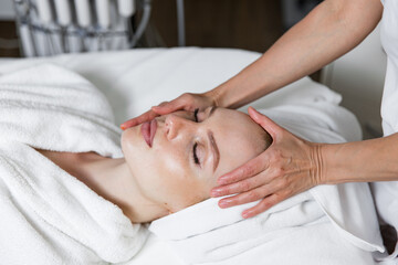Fototapeta na wymiar skin care in a spa beauty salon, a woman makes a medical procedure for the health of her facial skin.