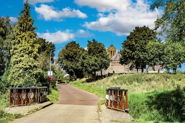 Fototapeten Beautiful Limburg countryside landscape, empty road to rural village and medieval church - Venlo (Hout Blerick), Netherlands © Ralf