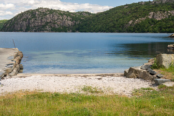 Small sand beach by a fjord.