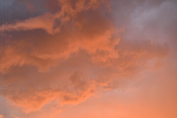 evening sunset, rays of the sun through cirrus pink clouds against the background of the sunset sky,	
