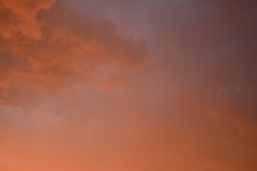 Obraz premium evening sunset, rays of the sun through cirrus pink clouds against the background of the sunset sky, 