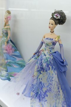 Barbie dolls at the toy fashion show in Montreal, Canada. Plastic figurines of stylish fashionable ladies are showing beautiful ball gowns, dresses with design inspired by painters and flowers.