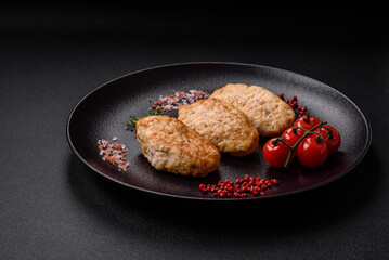 Delicious juicy cutlets or meatballs from minced chicken with salt and spices