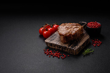 Delicious juicy pork or beef steak cooked on the grill with salt and spices