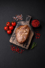 Delicious juicy pork or beef steak cooked on the grill with salt and spices