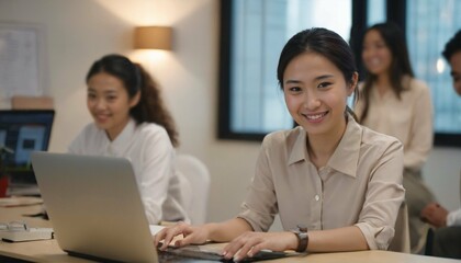 Office background with an Asian office girl working on her laptop computer, immersed in work with a radiant smile