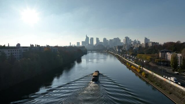 Bird's-eye Seine view: Paris, &Icirc;le de la Jatte, La D&eacute;fense, barge under sunlight.
