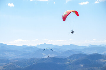 Fototapeta na wymiar paragliders in the sky over the mountains
