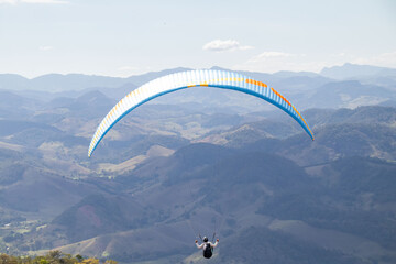 paraglider flying over the mountains