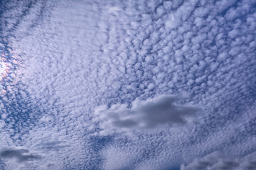 Summer evening sky in the picturesque clouds, lit by the rays of the setting sun.