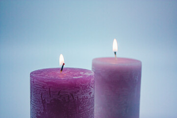 Decorative, colorful burning candles. Photograph.