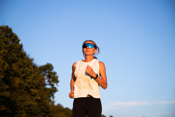 fit woman running at sunset