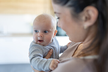 Happy mother enjoying moment with newborn baby girl in hug