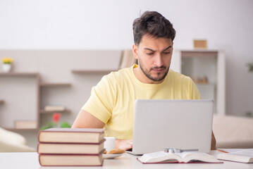 Young male student studying at home