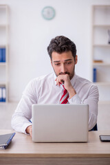 Young male employee working in the office