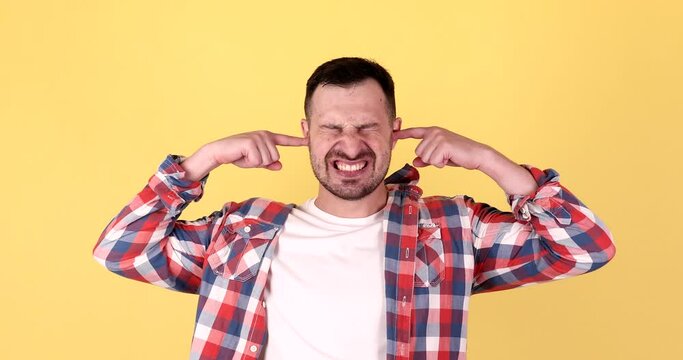 Don't want to hear and listen. Frustrated annoyed irritated man covering ears and gesturing no, avoiding advice ignoring unpleasant noise loud voices.