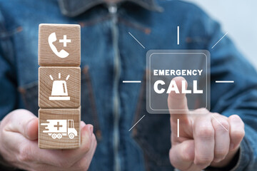Man holding wooden cubes with icons and clicks text: EMERGENCY CALL. Concept of emergency call and...