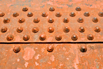 Rusted Rivet Abstract. Old rusted button rivets in staggered pattern 