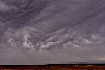 Fototapeta na wymiar Unusual downward billowing Storm Clouds and torrential rains heading our way, north of Farson, Wyoming . Waiting for lightening and thunder clap
