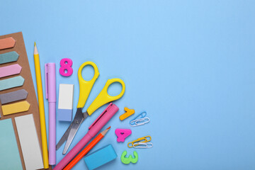 Flat lay composition with different school stationery on light blue background, space for text. Back to school