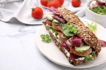 Delicious sandwich with schnitzel on white table, closeup. Space for text