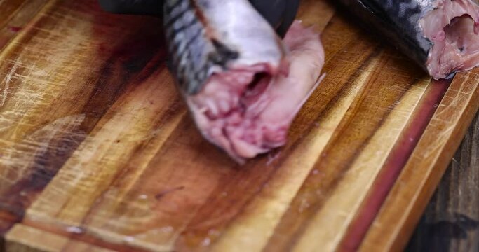 sliced mackerel during the preparation of a fish dish, raw butchered mackerel during cooking