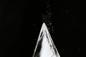 Triangle shape ice block on black background