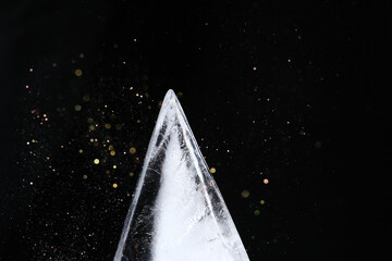 Triangle shape ice block on black background