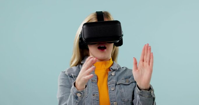 Virtual reality, woman and surprise with 3D experience, scroll with metaverse and future technology on blue background. Hands, connection and software gaming, holographic and wow for scifi in studio
