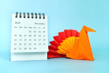 Selective focus of November 2023 desk calendar with turkey bird paper decoration. Thanksgiving day...